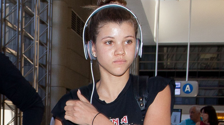 Sofia Richie wearing headphones while wearing an Iron Maiden t-shirt