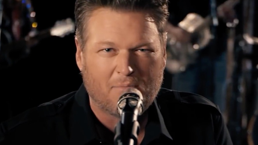 Blake Shelton singing in his "Minimum Wage" music video 