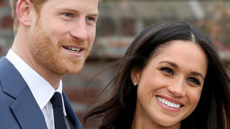 Prince Harry and Meghan Markle leaning in