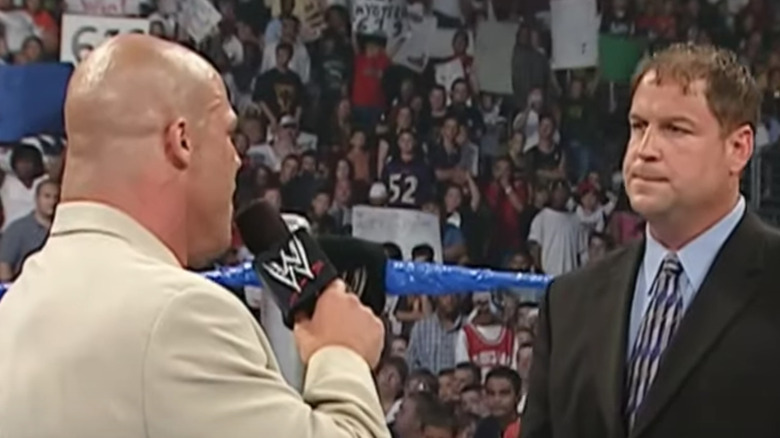 Tony Chimel frowning Kurt Angle microphone