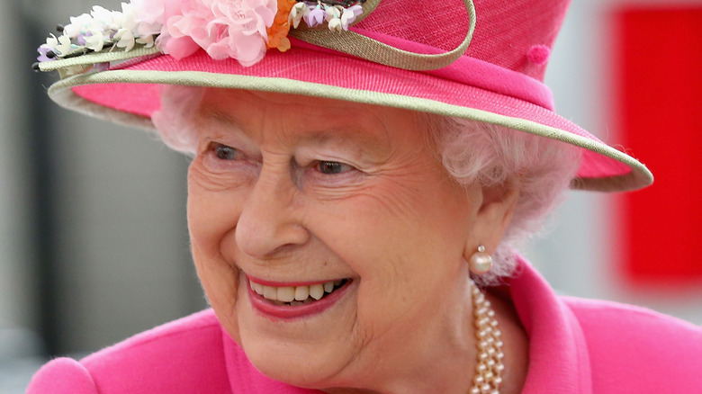 Queen Elizabeth II wearing a pink skirt suit