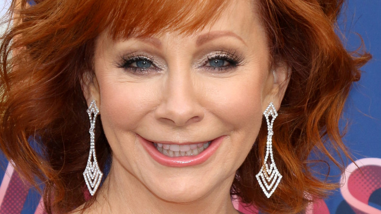 Reba McEntire poses in sparkly earrings.