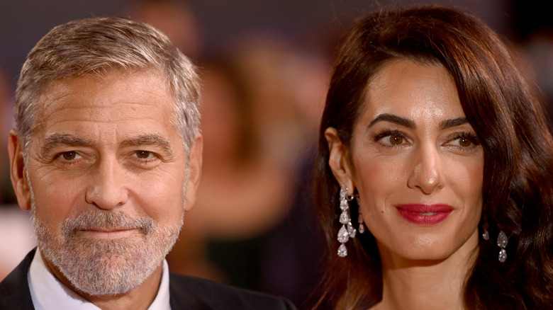 Amal and George Clooney posing for photo