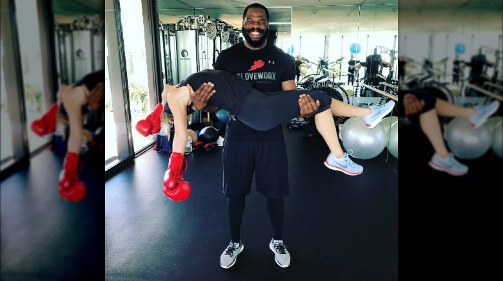 Trainer Leyon Azubuike holding Jennifer Aniston after a boxing session