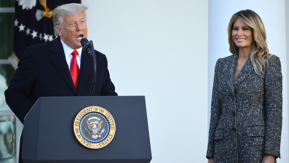 Melania Trump standing by Donald Trump's side during a speech