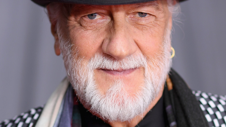 Mick Fleetwood with a gray beard and checkered jacket