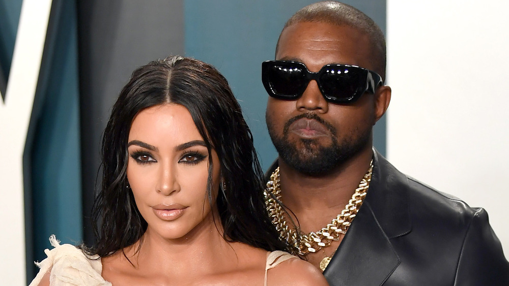 Kim Kardashian West and Kanye West posing for cameras