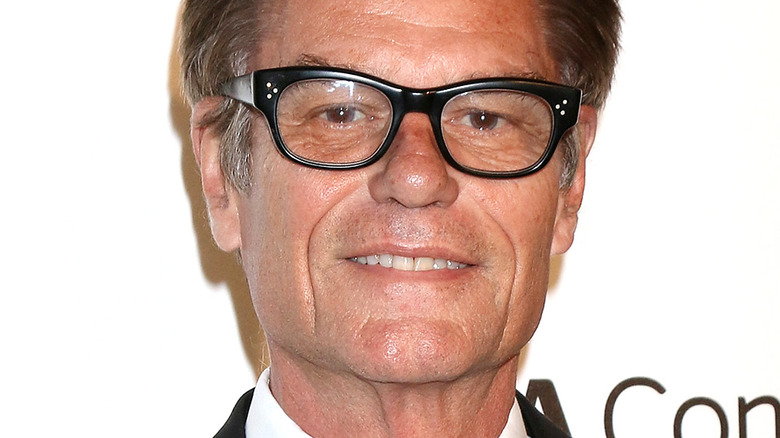 Harry Hamlin smiling in glasses at an event