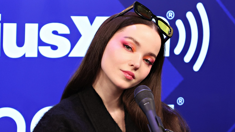 Dove Cameron poses at an event