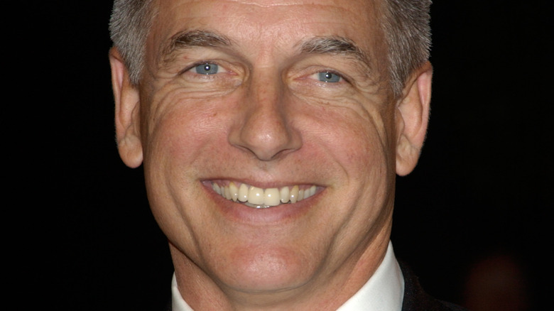 Mark Harmon smiles in a suit and white tie