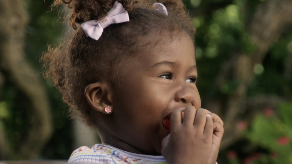 Young girl eating an apple