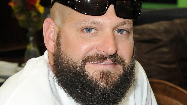 Jarrod Schulz smiling with sunglasses on head