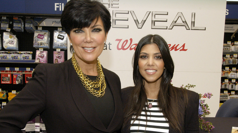 Kourtney Kardashian poses next to her mother, Kris Jenner