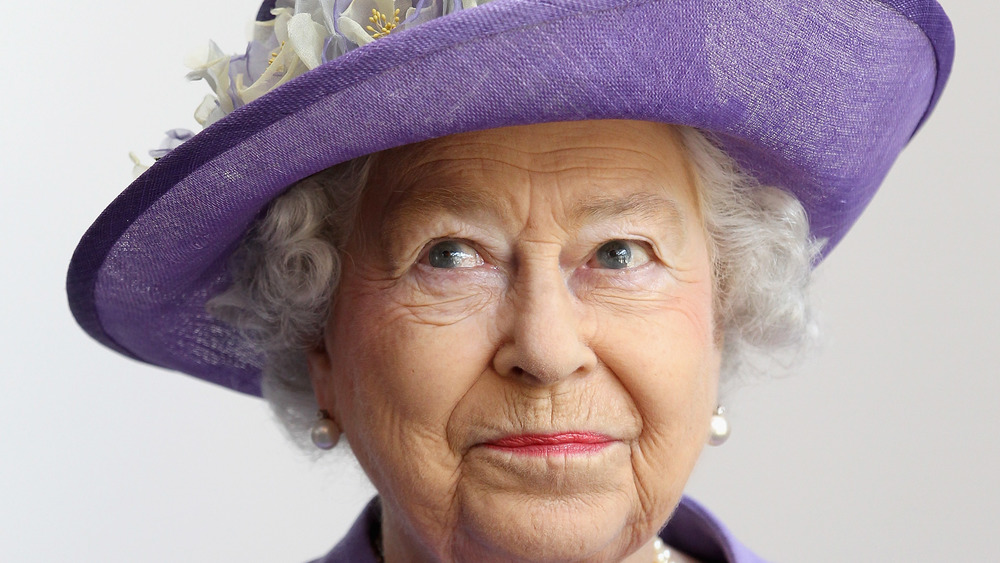 Queen Elizabeth posing in a hat