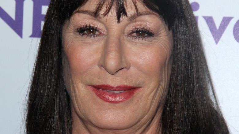 Anjelica Huston smiles in red lipstick