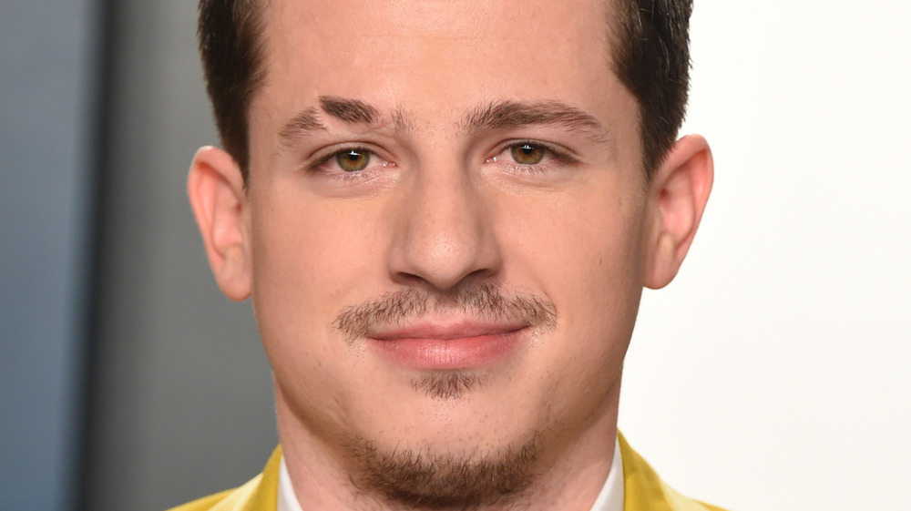 Charlie Puth, smirking, red carpet in 2020, close up of face, short hair, facial hair