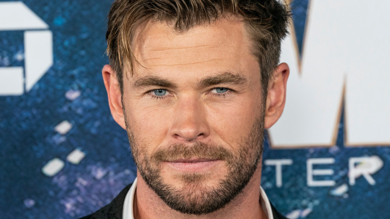 Chris Hemsworth smiling with a short scruffy beard