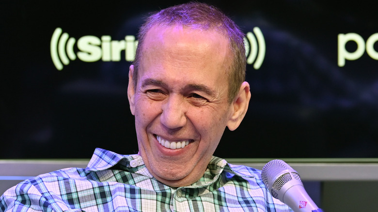 Gilbert Gottfried laughing in front of microphone