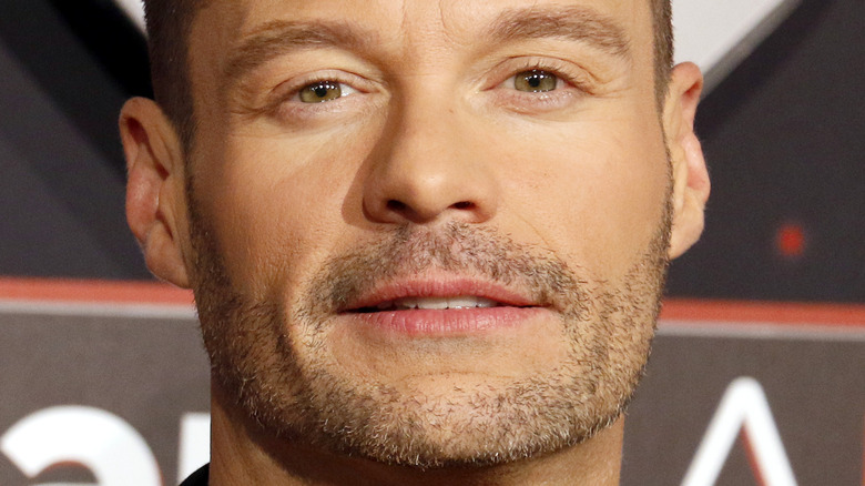 Ryan Seacrest smirking 