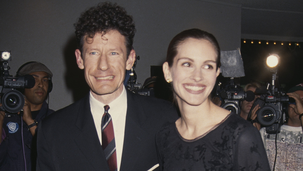 Lyle Lovett and Julia Roberts smiling on the red carpet