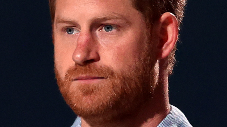 Prince Harry in front of dark background