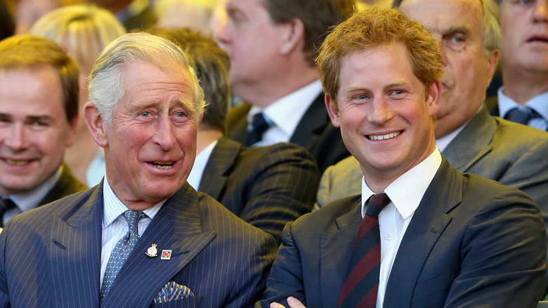 Prince Charles sitting with Prince Harry