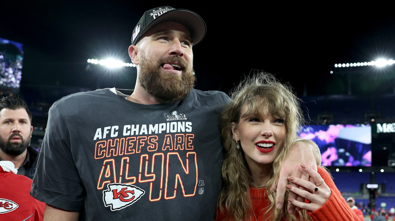 Taylor Swift and Travis Kelce embracing after NFL game