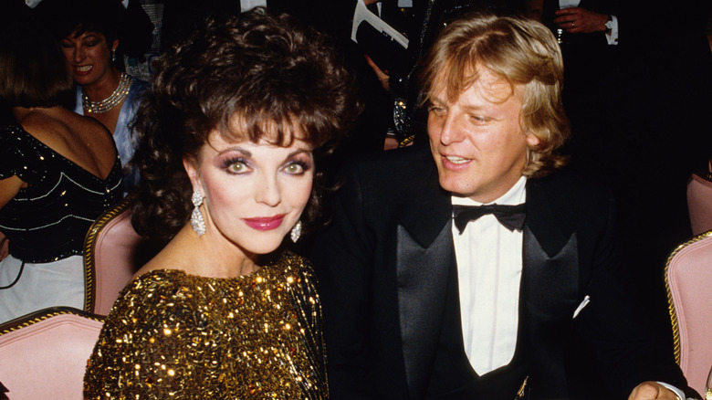 Joan Collins and Peter Holm at an event.