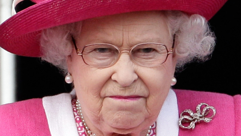 Queen Elizabeth II watches a horse race 