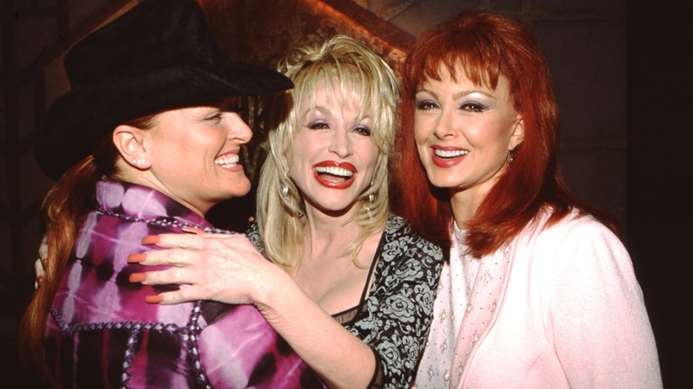 Dolly Parton shares a hearty laugh with Naomi and Wynonna Judd.