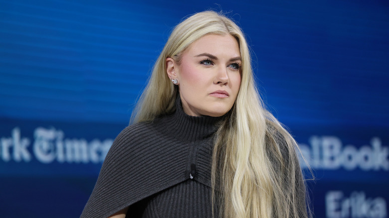 Erika Kirk in a dark-gray sweater with her long blond hair worn down