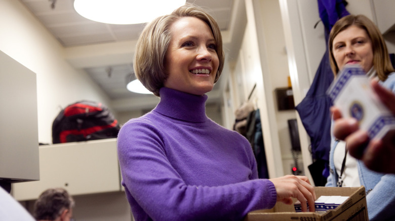 Dana Perino handing out M&Ms to the White House press corps.