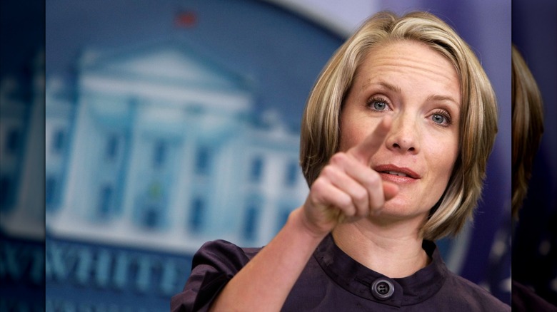 Dana Perino pointing to someone in a press briefing.