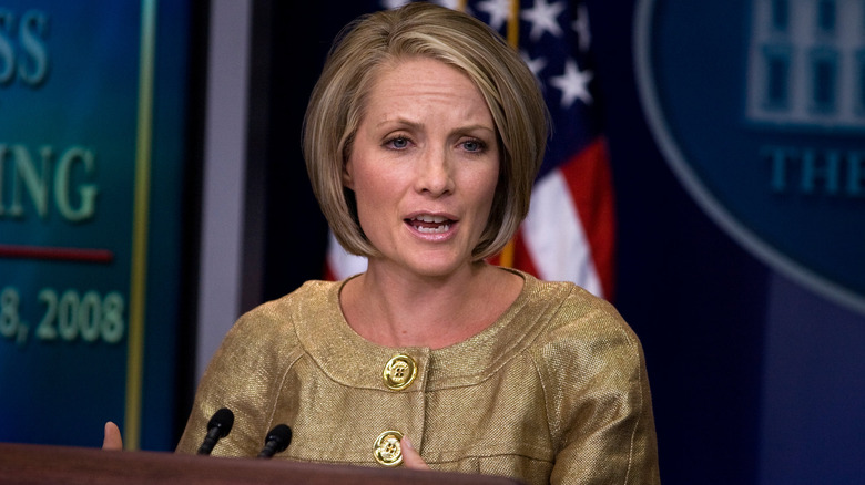 Dana Perino speaking to White House reporters in a gold top