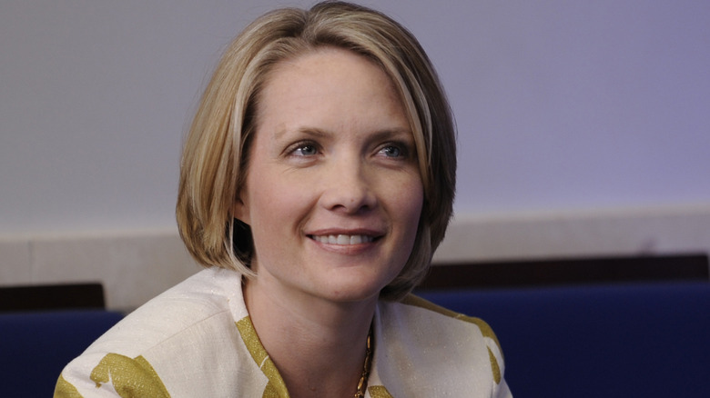 Dana Perino smiles in a green and white blouse.