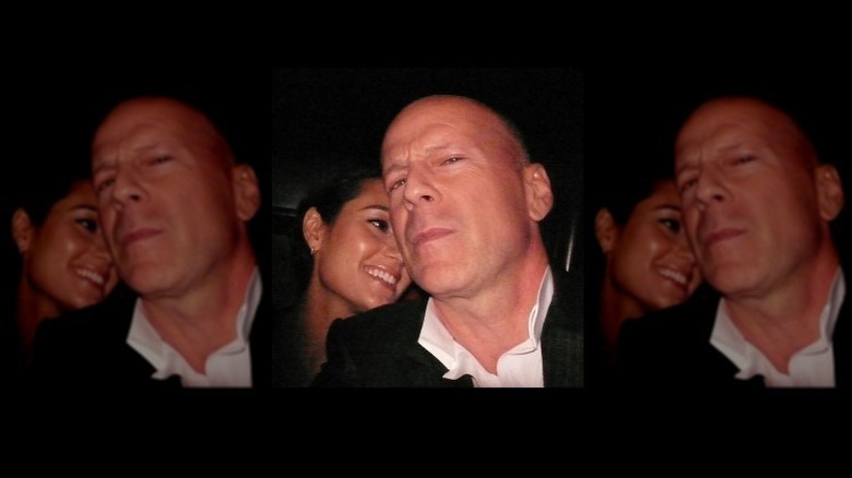Bruce Willis and Emma Heming Willis posing