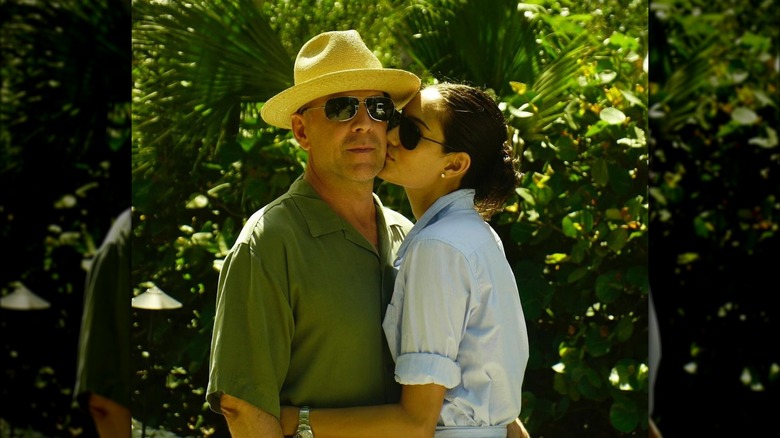 Bruce Willis and Emma Heming Willis in front of a bush