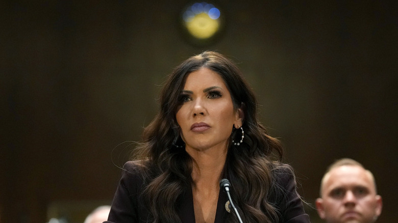 Kristi Noem at a microphone