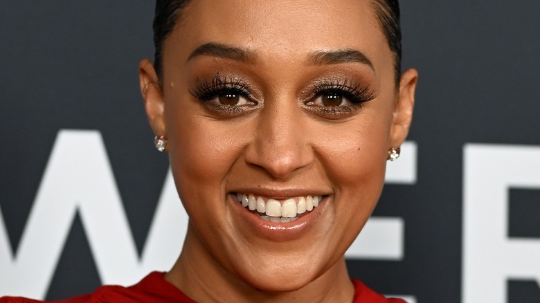 Tia Mowry smiles at an event