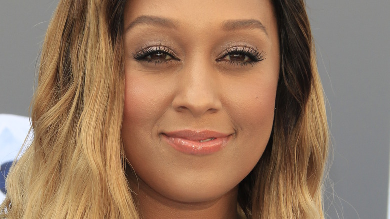 Tia Mowry smiles at an event
