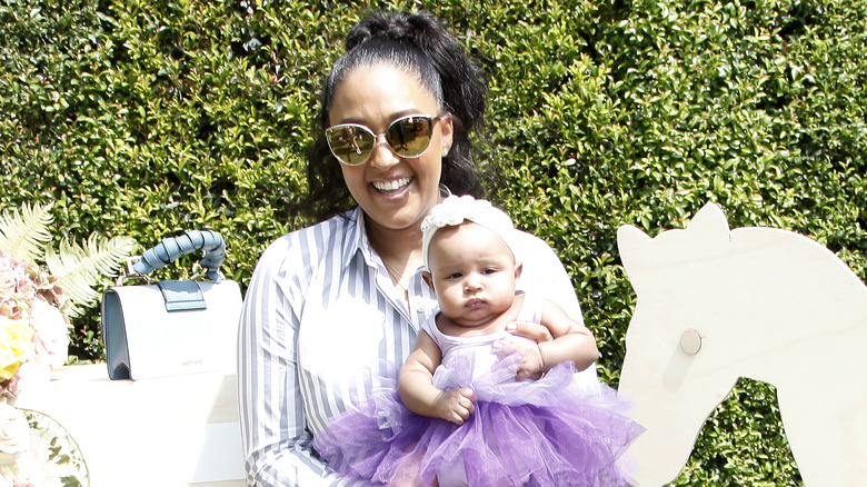 Tia Mowry holding her daughter Cairo 