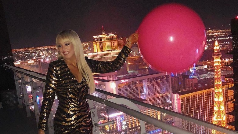 Tiffany Trump poses in party dress atop a building at night