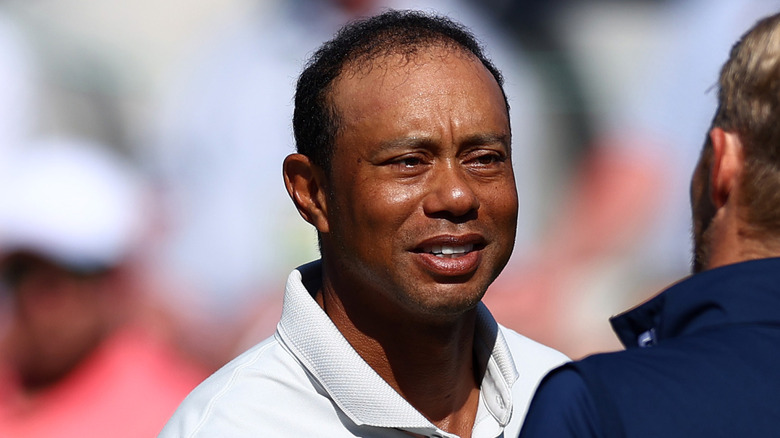Tiger Woods shaking hands on the golf course