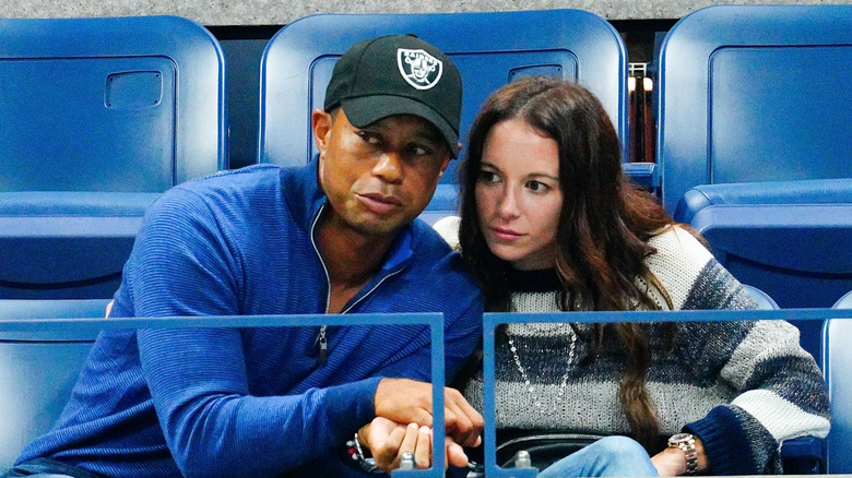 Erica Herman and Tiger Woods close together