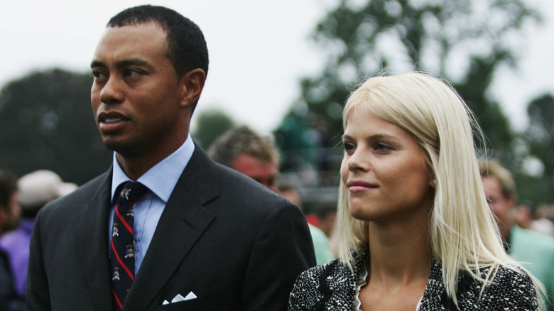 Tiger Woods and then-wife Elin Nordegren walk together