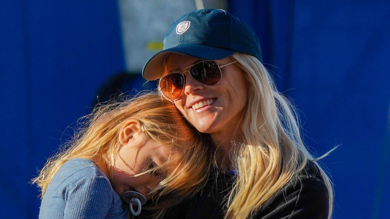 Elin Nordegren smiling and holding her daughter Zeta