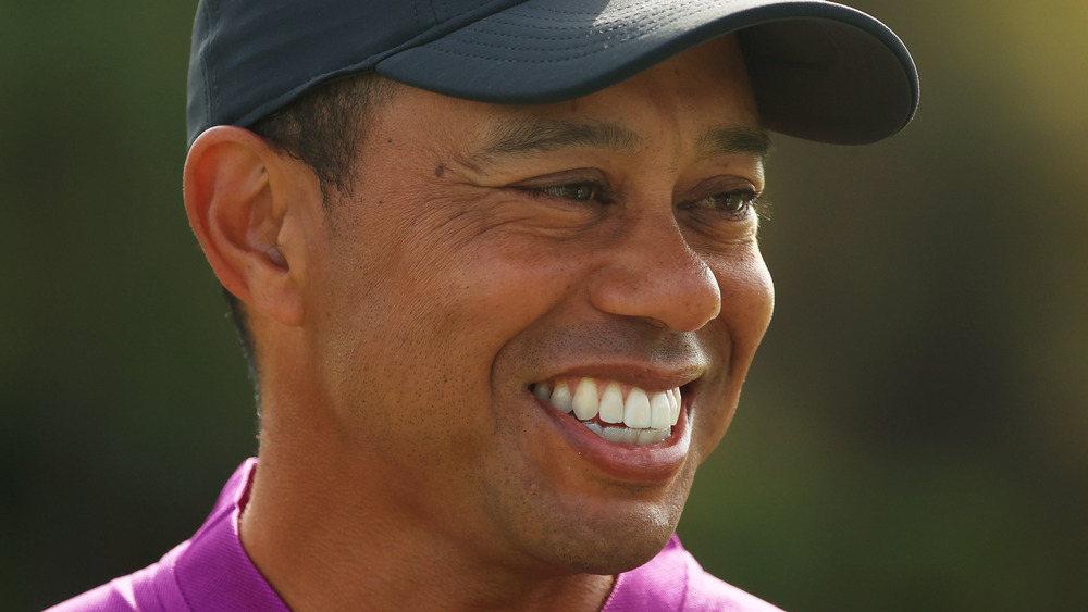 Tiger Woods smiling on the golf course