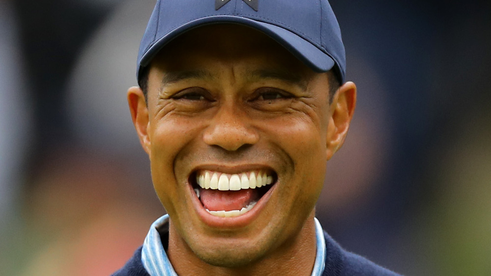 Tiger Woods laughing while playing golf