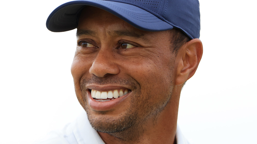 Tiger Woods smiling in a hat