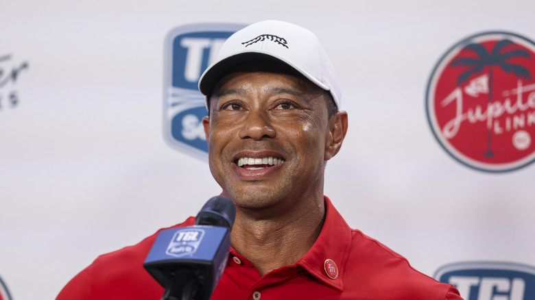 Tiger Woods smiling at a press event